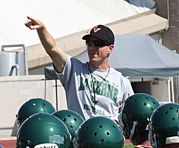 Leopard head coach Chris Krich addresses team during the first day of football practice