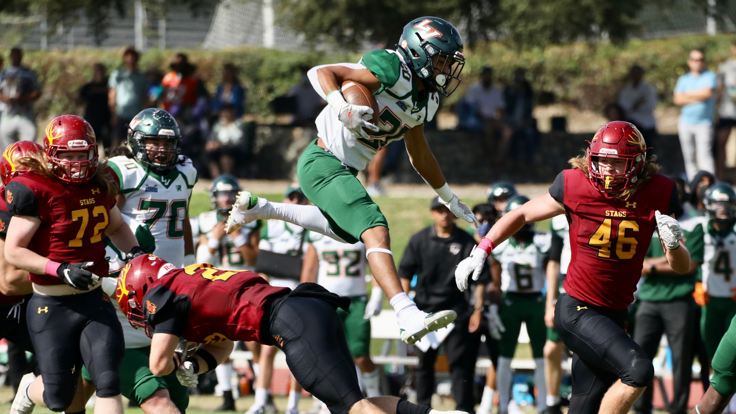 Able Cueva hurdles a defender during the Leopards game at CMS.