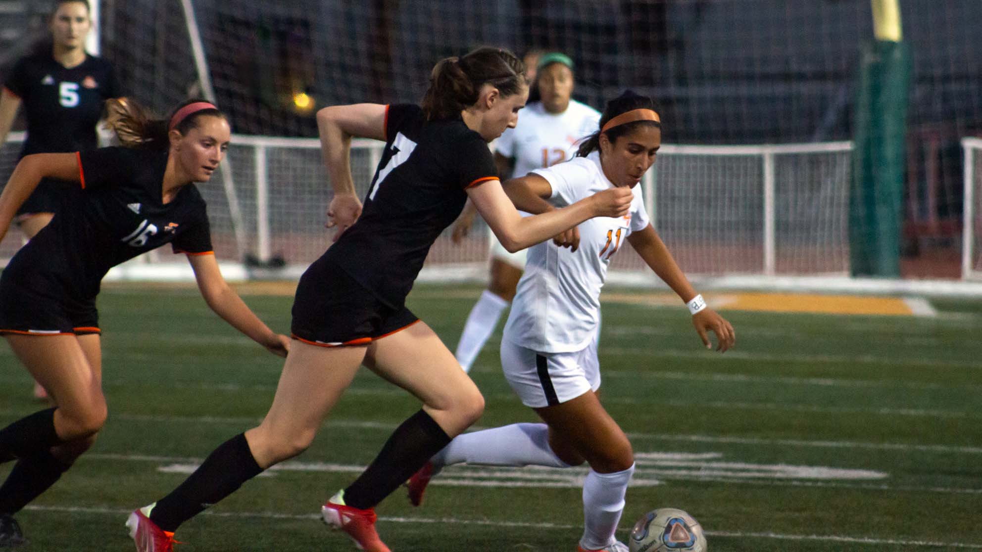 Valerie Vera battles for possession in La Verne's season opener against Occidental.